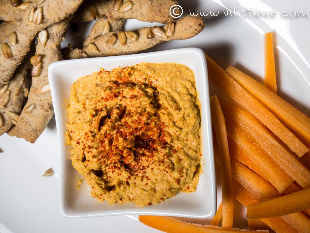 Homemade hummus with crispy rice sticks