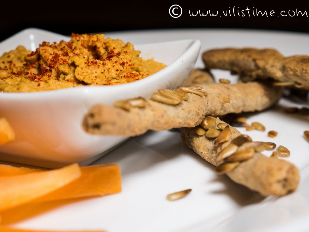 Homemade hummus with crispy rice sticks