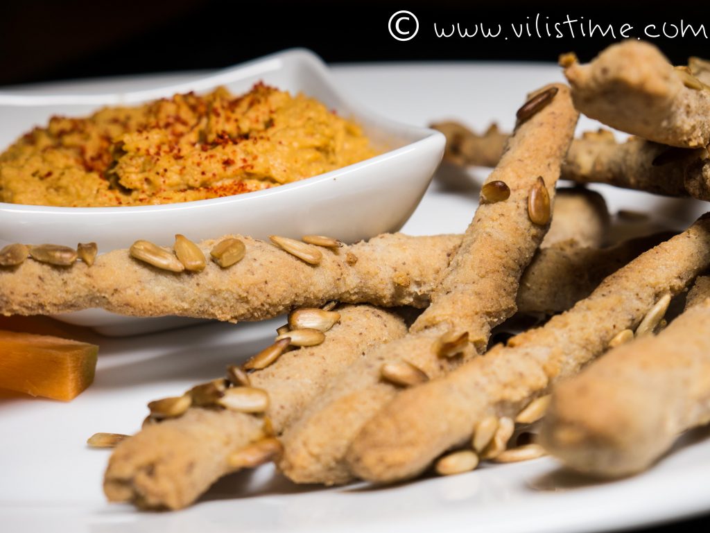 Homemade hummus with crispy rice sticks